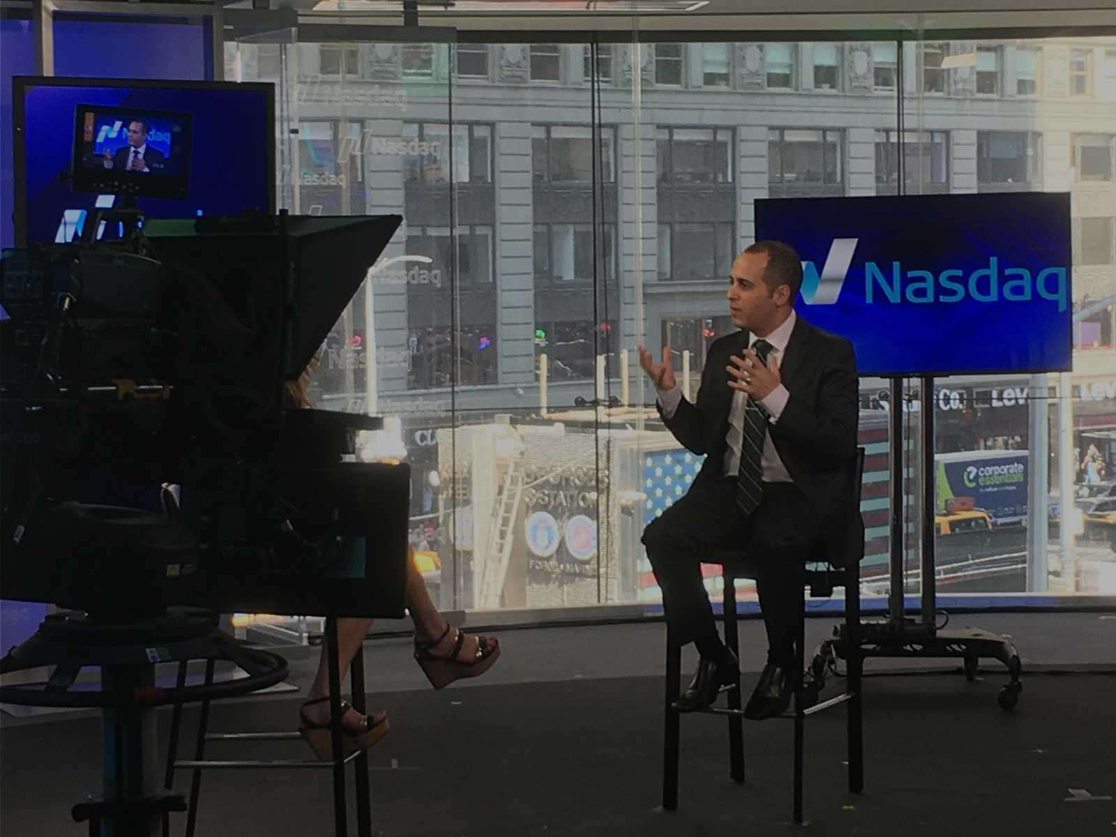 Adam Sarhan being interviewed on set at the Nasdaq MarketSite in Times Square